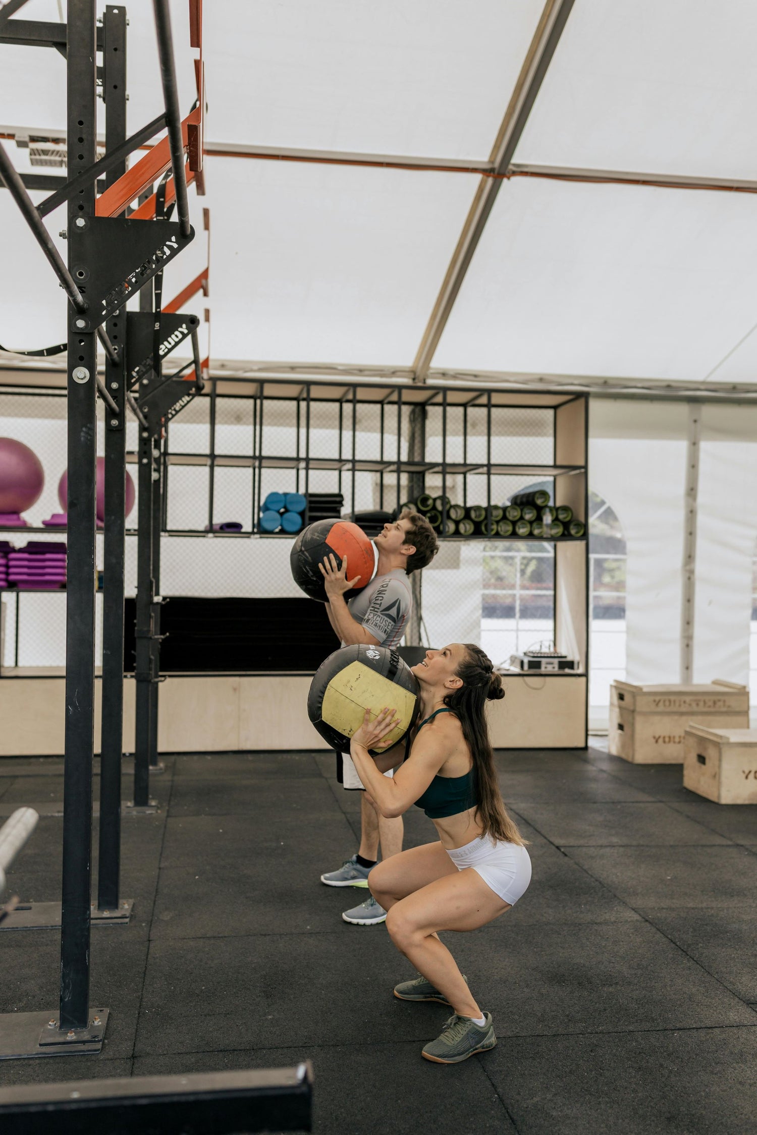 man and woman doing wall balls